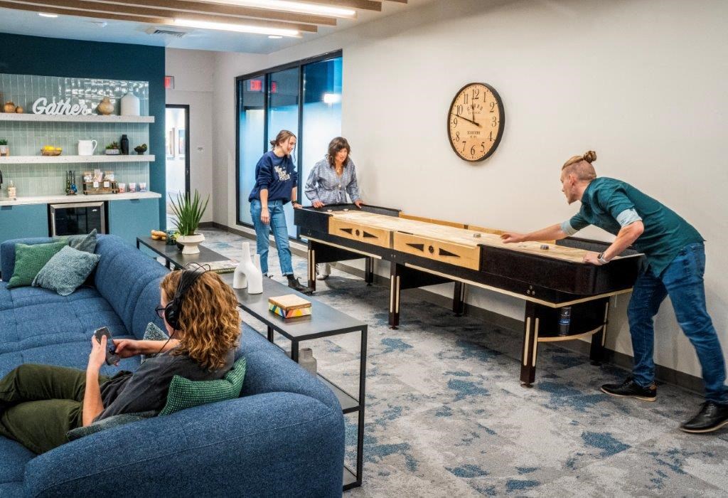 a group of people playing shuffleboard in a living room