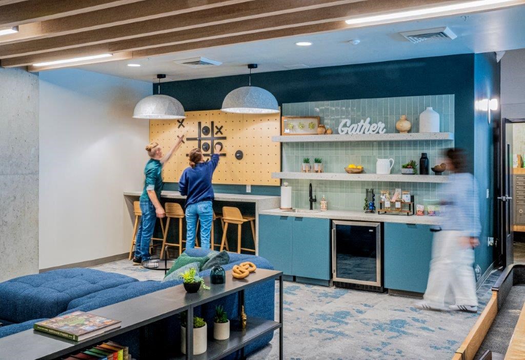 two men working on a wall in a living room