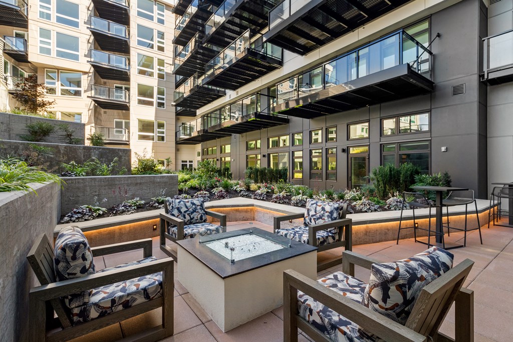Vela Apartments outdoor firepit Vela Apartments outdoor patio with a firepit and lounge chairs