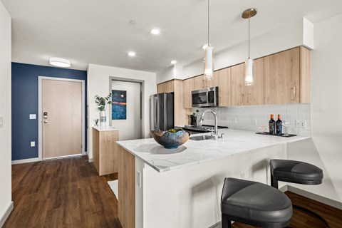 a kitchen with a large island with a white counter top