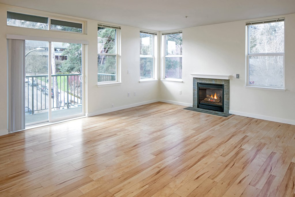 a living room with a fireplace and a wooden floor