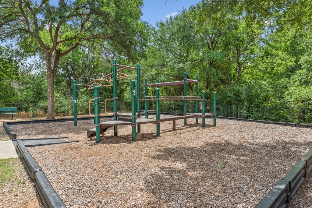 A playground with a swing set and a slide.