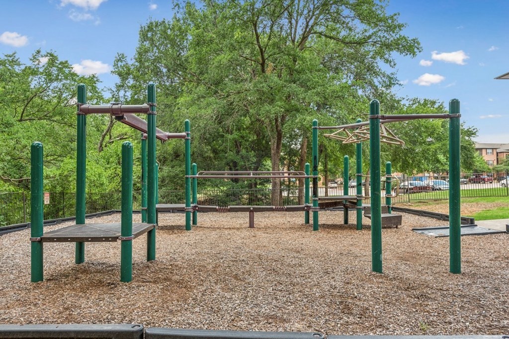 A playground with a swing set and a seesaw.