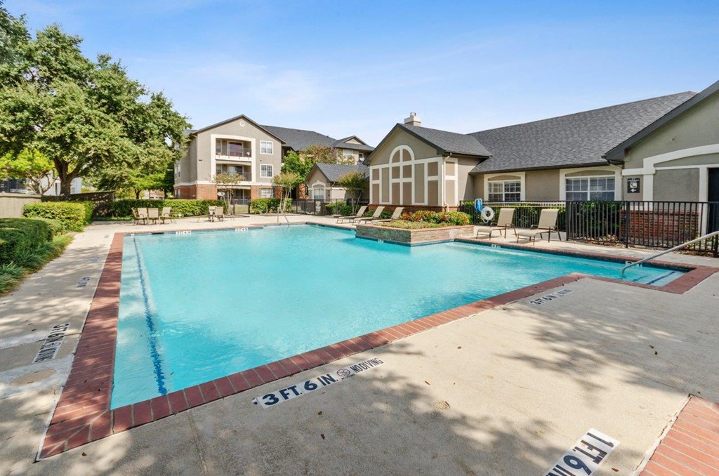 Valley Trails Apartments in Irving, Texas Clubhouse Exterior and Pool with Lounge Chairs