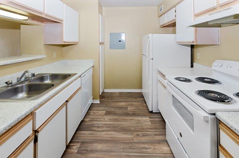 a kitchen with a stove sink and refrigerator