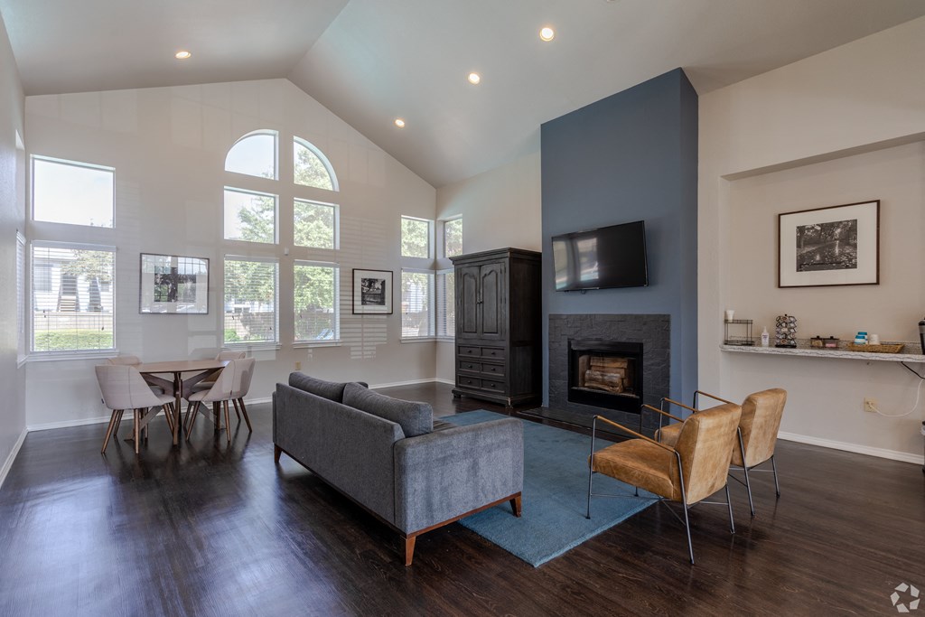 an open living room with a fireplace and a table with chairs