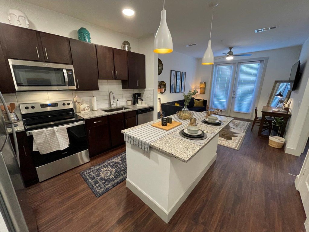 Valor at the Realm in Lewisville, Texas Model Kitchen with Island and Living Room