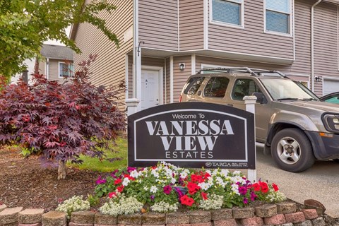 A sign that says "Vanessa View Estates" is in front of a house.
