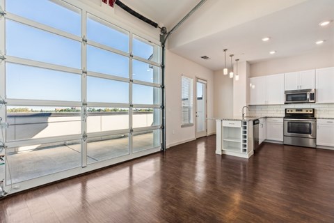 A spacious kitchen with a large window and a view of the outdoors.