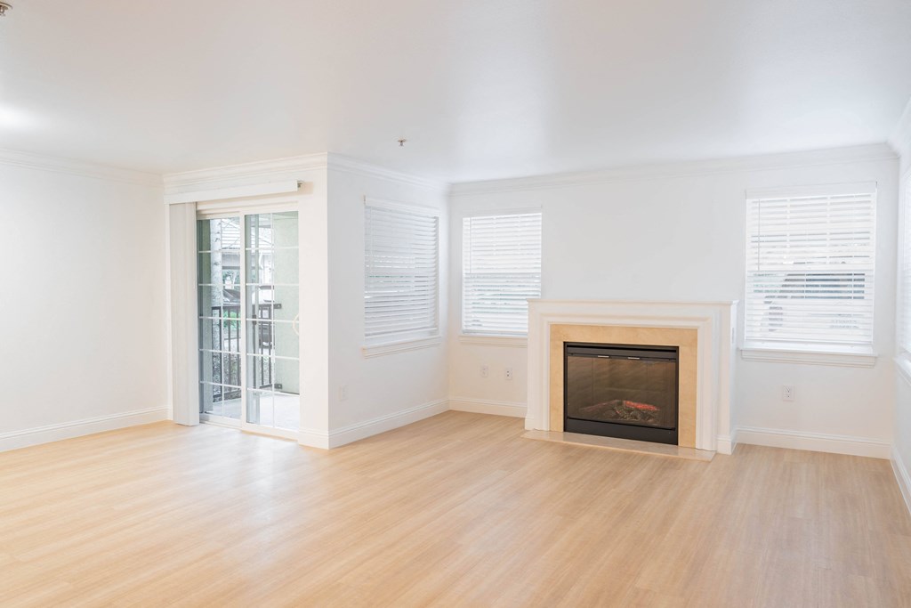 a living room with a fireplace and hardwood floors