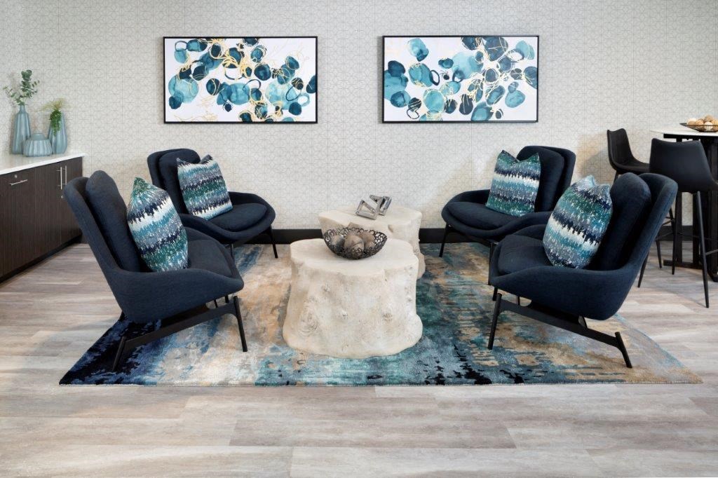 a living room with four chairs and a coffee table