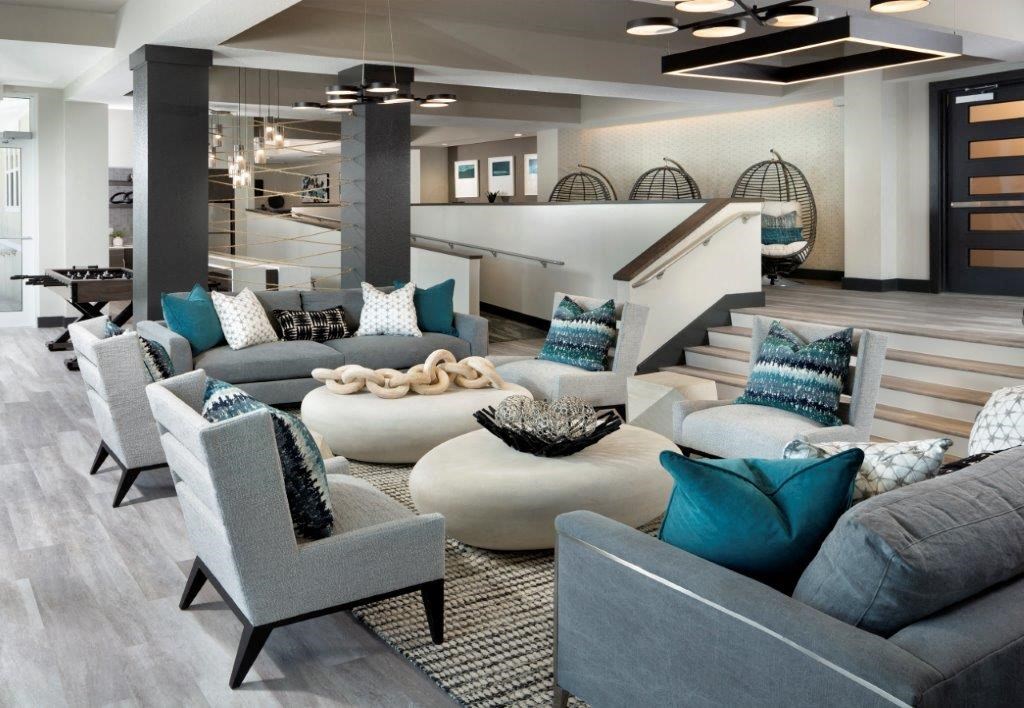 a living room filled with furniture and a staircase