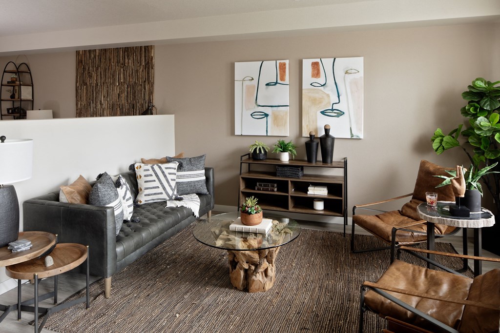 a living room filled with furniture and a large painting on the wall