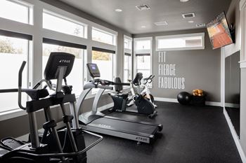 a gym with treadmills and other exercise equipment