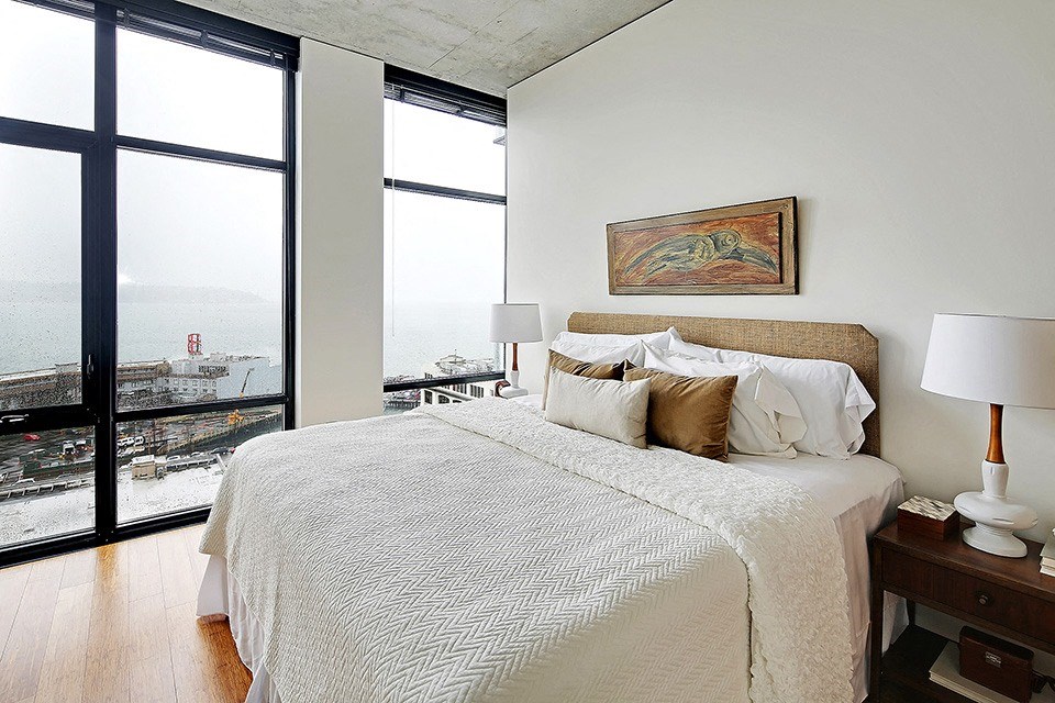 a bedroom with a large bed and a large window