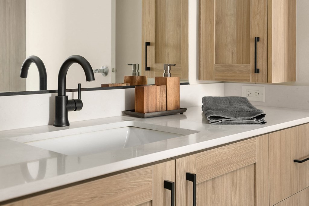 a kitchen with a sink and a black faucet