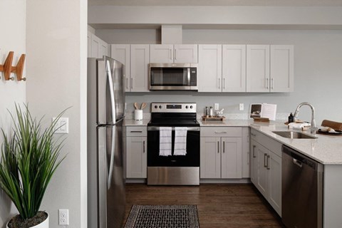 a kitchen with stainless steel appliances and white cabinets