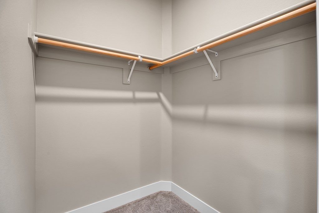 A white wall with a shelf and a white box with a brown substance in it.