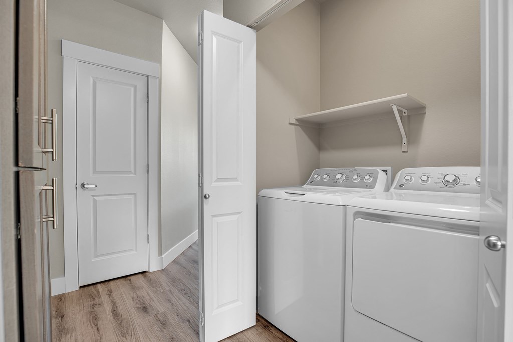 A white laundry room with a washer and dryer.