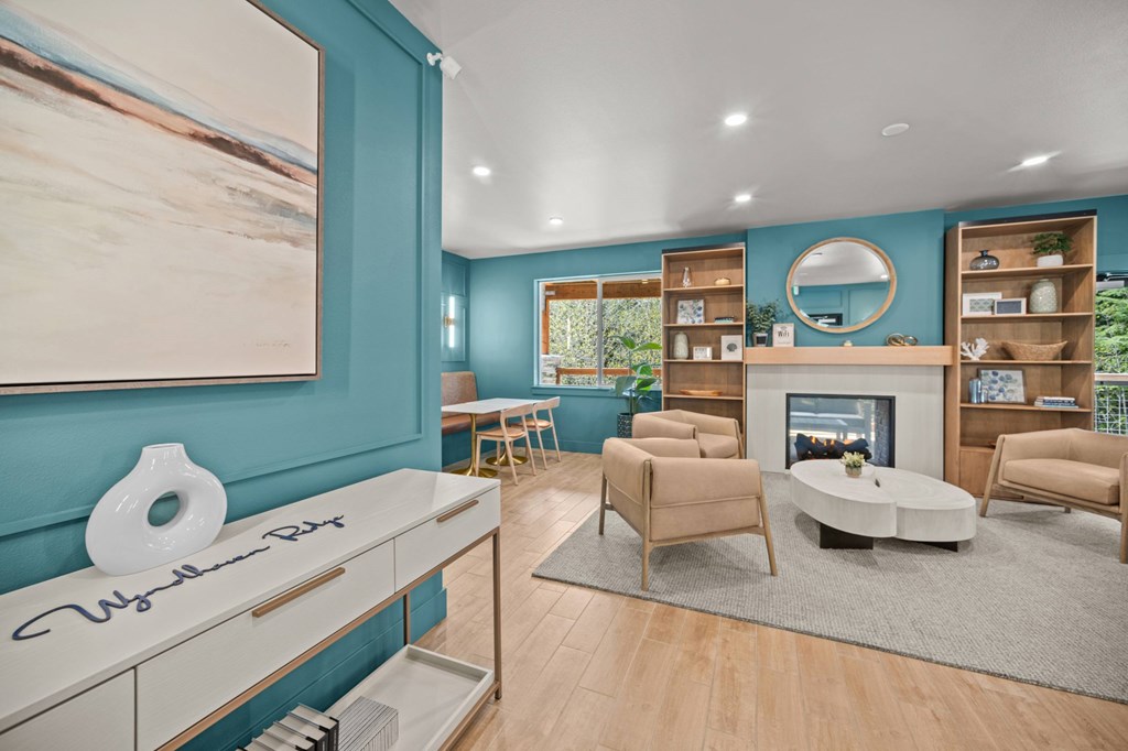 A living room with a fireplace and a painting on the wall.