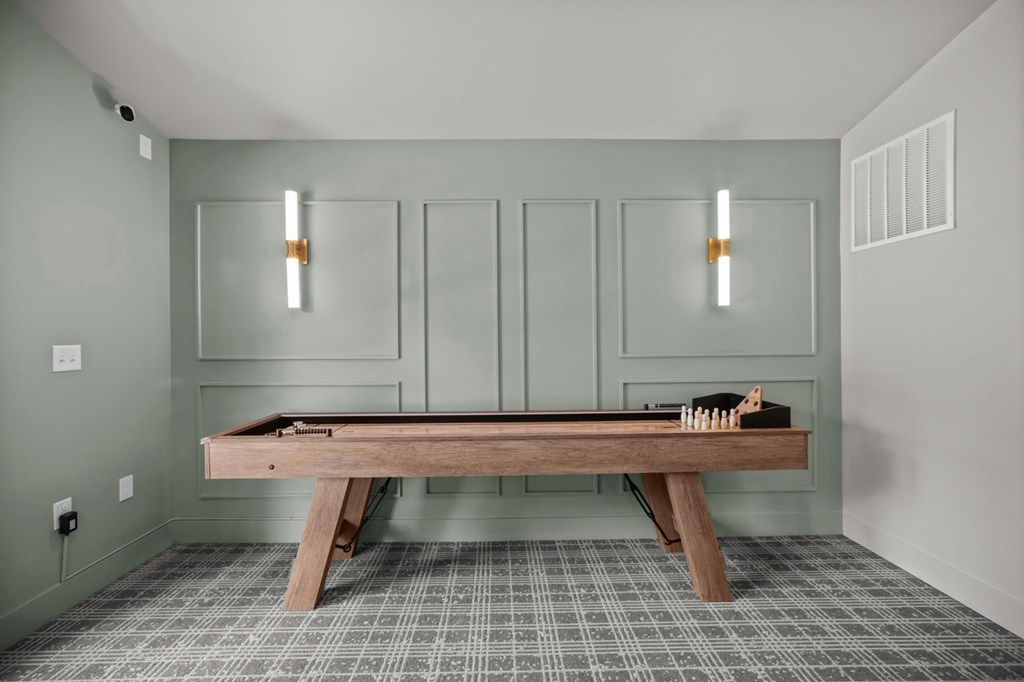 A room with a table and a pool table.