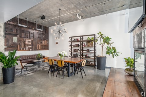 A modern dining room with a long table and chairs.