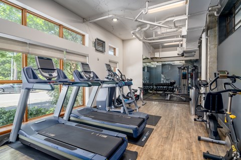 A gym with treadmills and exercise equipment.