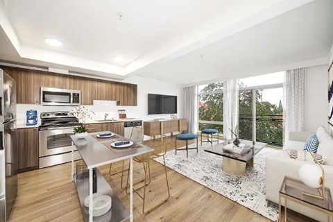 A modern kitchen with a dining table and chairs.