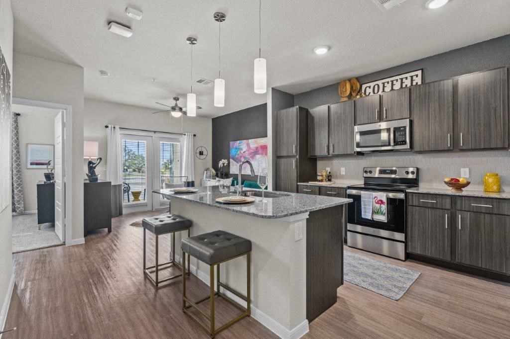 a kitchen with a large island with two stools