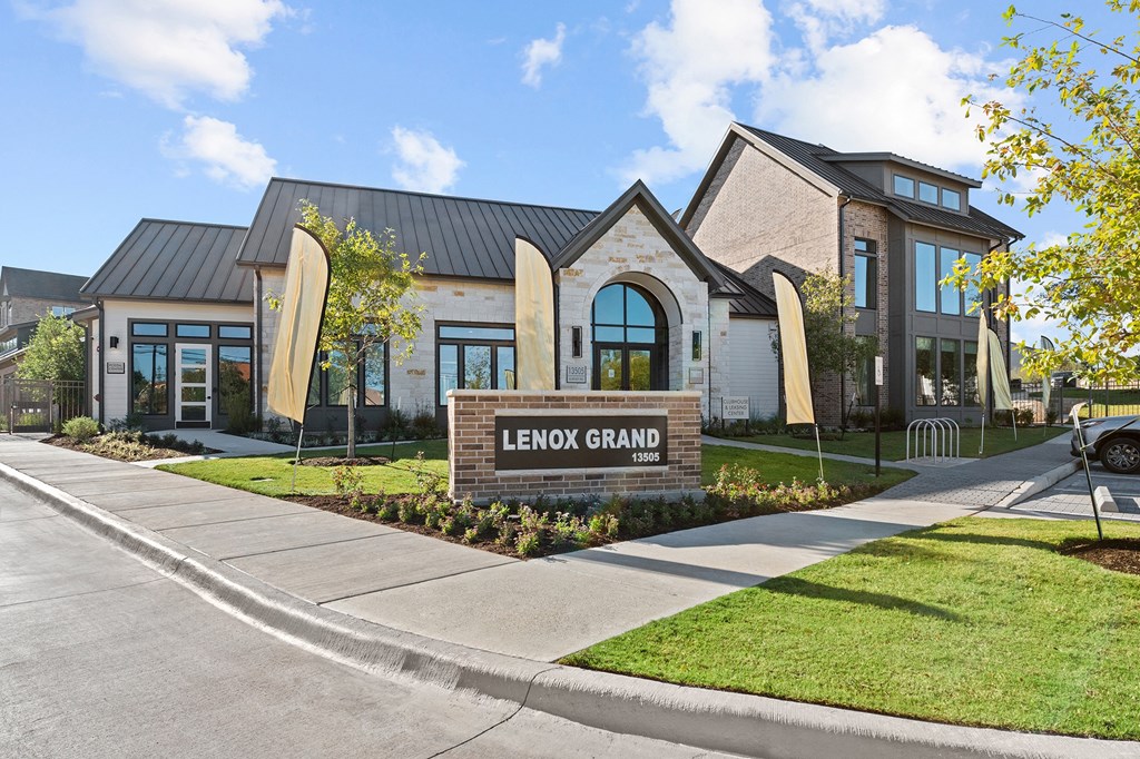 the grand building is shown with a sidewalk and grass at Lenox Grand, Austin Texas
