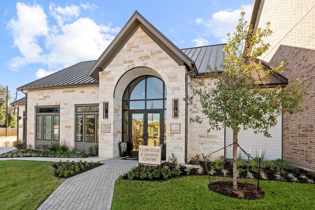 the front of a house with a tree in the front yard