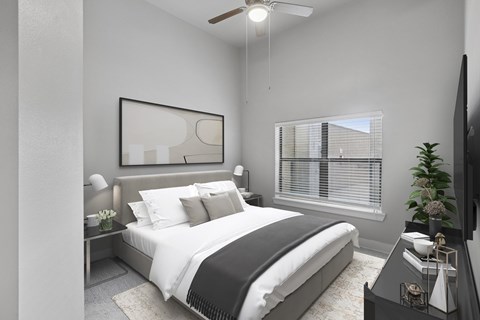 A modern bedroom with a large bed and a flat-screen TV.