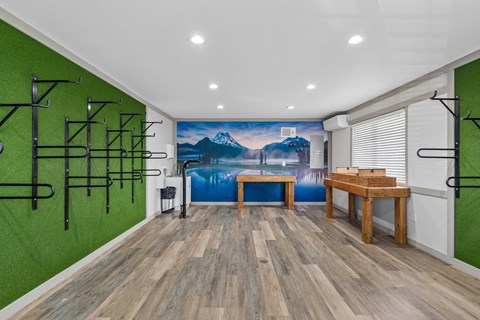 A room with a green wall and wooden flooring.