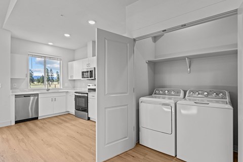 A laundry room with two washing machines and a dryer.