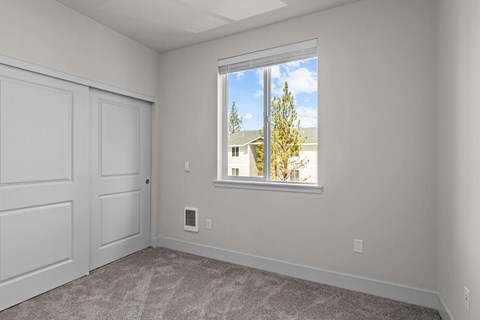 A room with a large window and a door.