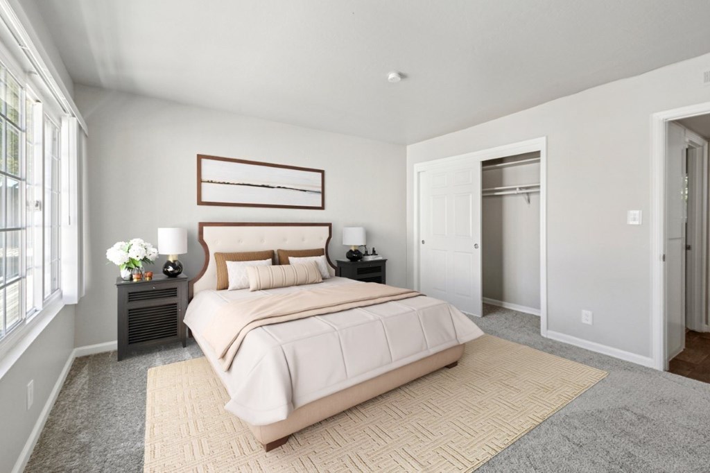 A bedroom with a large bed and a window.