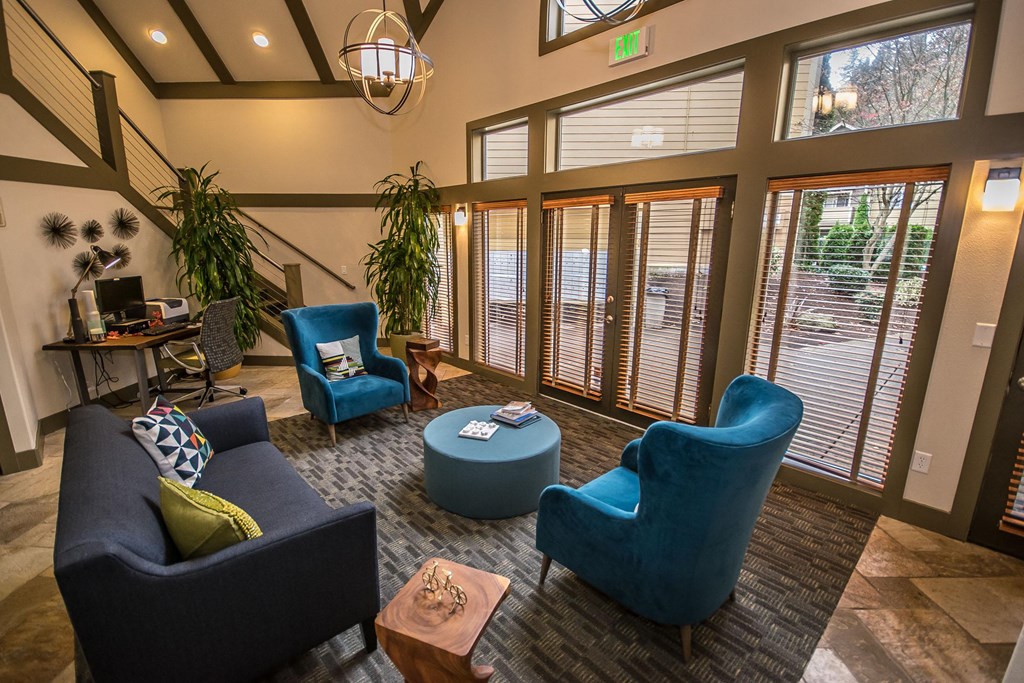 the lobby at Arnada Pointe with blue chairs and a table