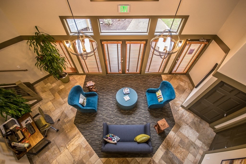 an overhead view of the lobby at Arnada Pointe with blue couches and chairs