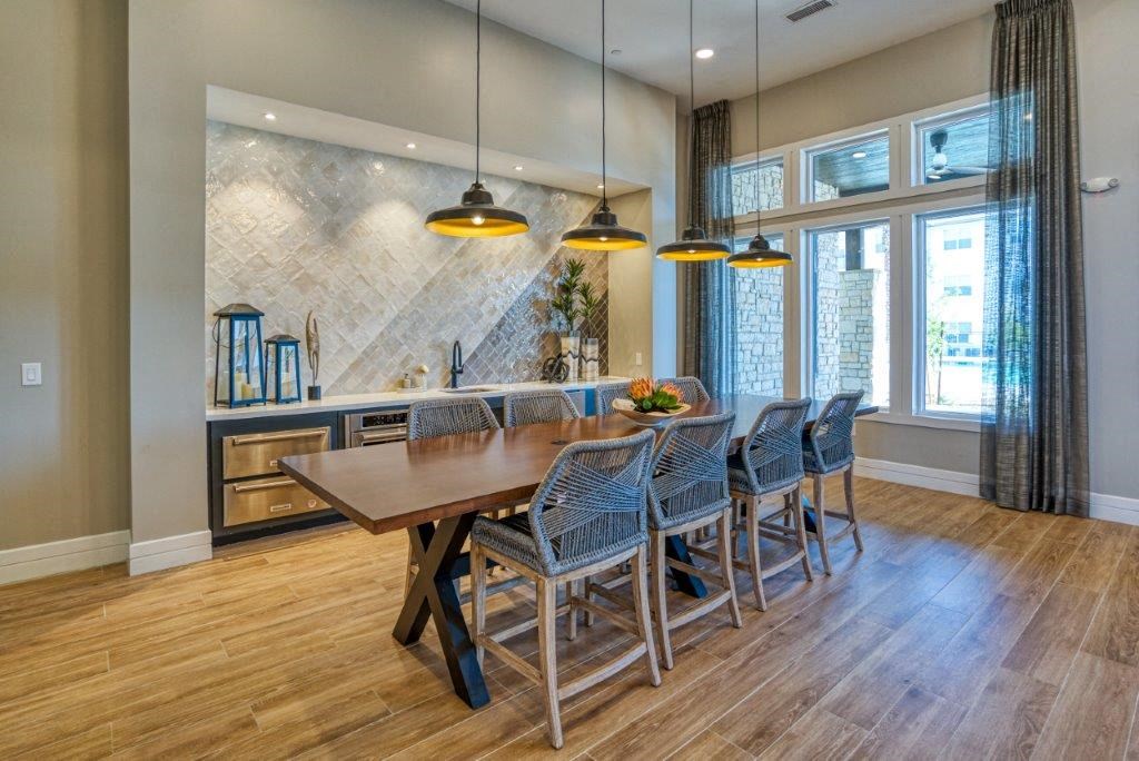 a large dining room with a wooden table and chairs