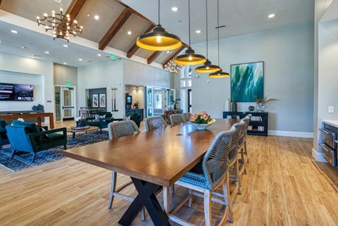 a large dining room with a long table and chairs