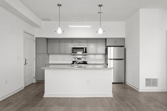 a kitchen with an island and stainless steel appliances