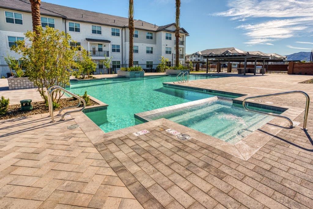 a swimming pool with a building in the background