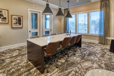a conference room with a long table and chairs