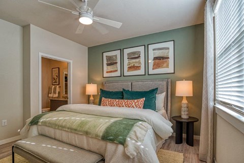 a bedroom with a bed and a ceiling fan