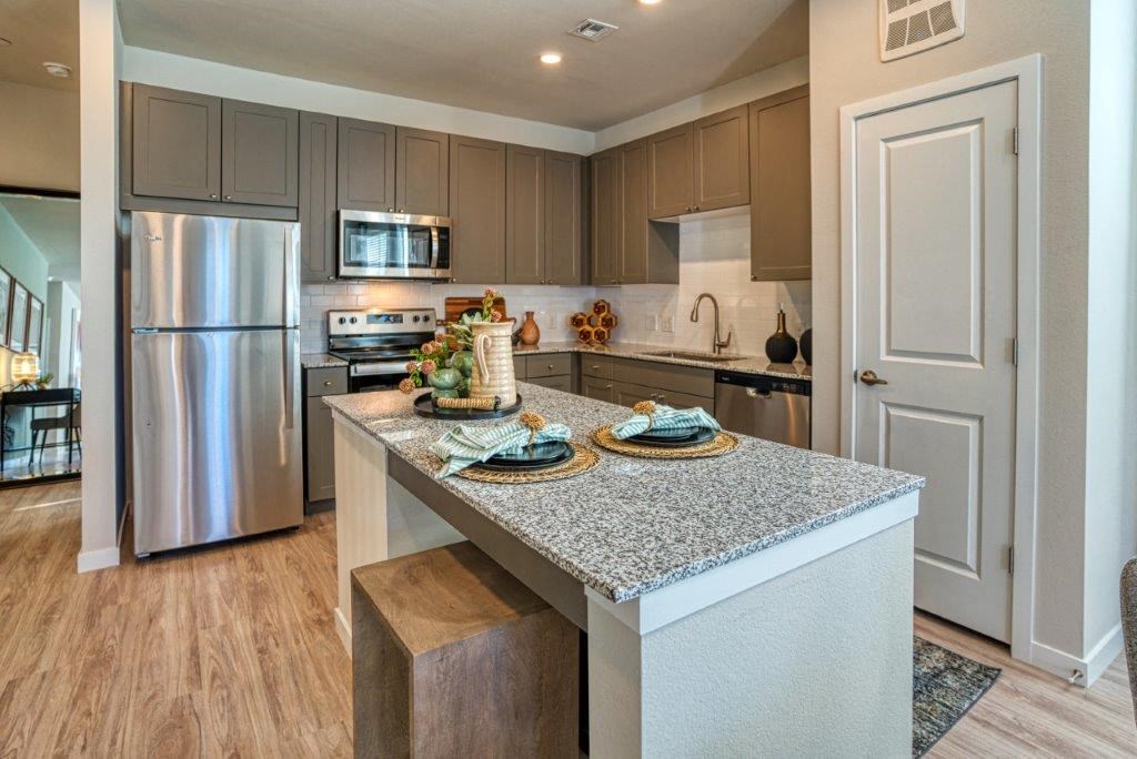 a kitchen with stainless steel appliances and a granite counter top
