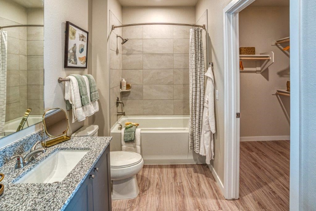 a bathroom with a shower toilet and a sink