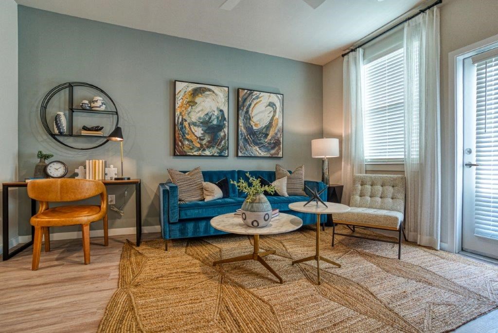 a living room with a blue couch and a table