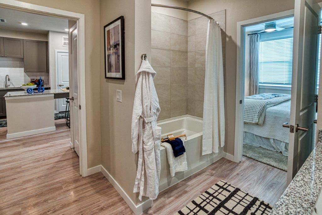 a bathroom with a shower and a bed in it