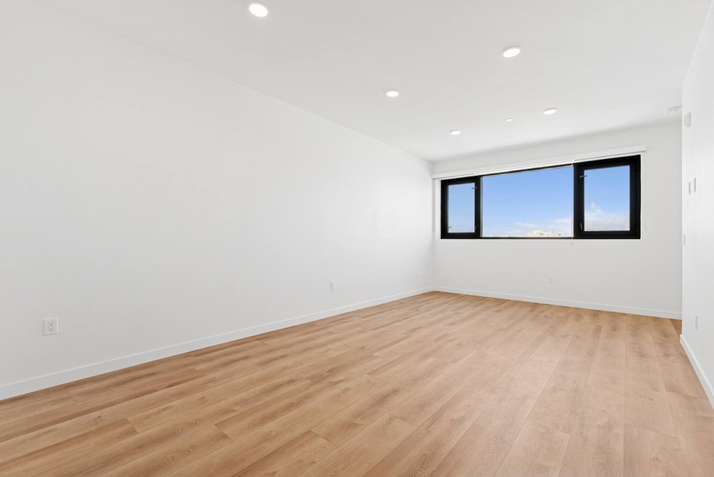 OnyxOnPark_SanDiego_CA_Vacant_2BR_ A room with wooden flooring and a window.