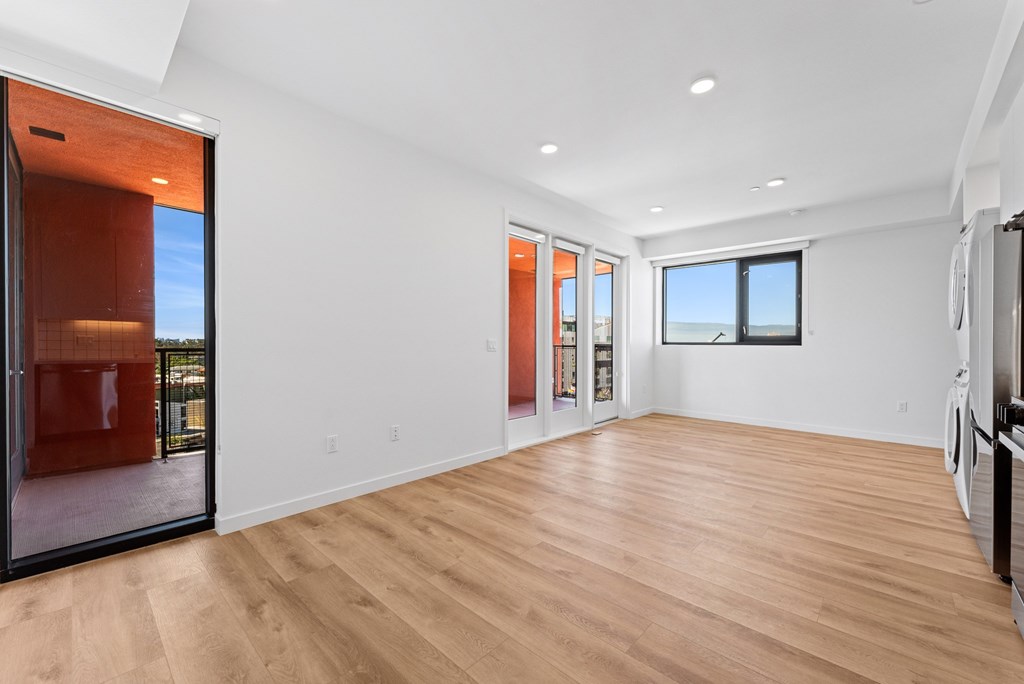 OnyxOnPark_SanDiego_CA_Vacant_2BR_B1_A spacious room with wooden flooring and a large window.